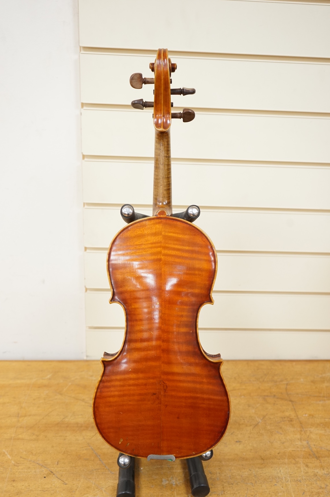Three cased violins; a German Dresden violin, supplied by Campbell and co., Glasgow, together with another Dresden Stradivarius copy, and the remains of a European violin.